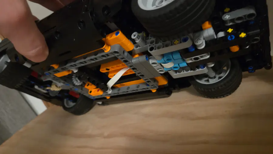 Underside showing chassis, suspension links, and drivetrain